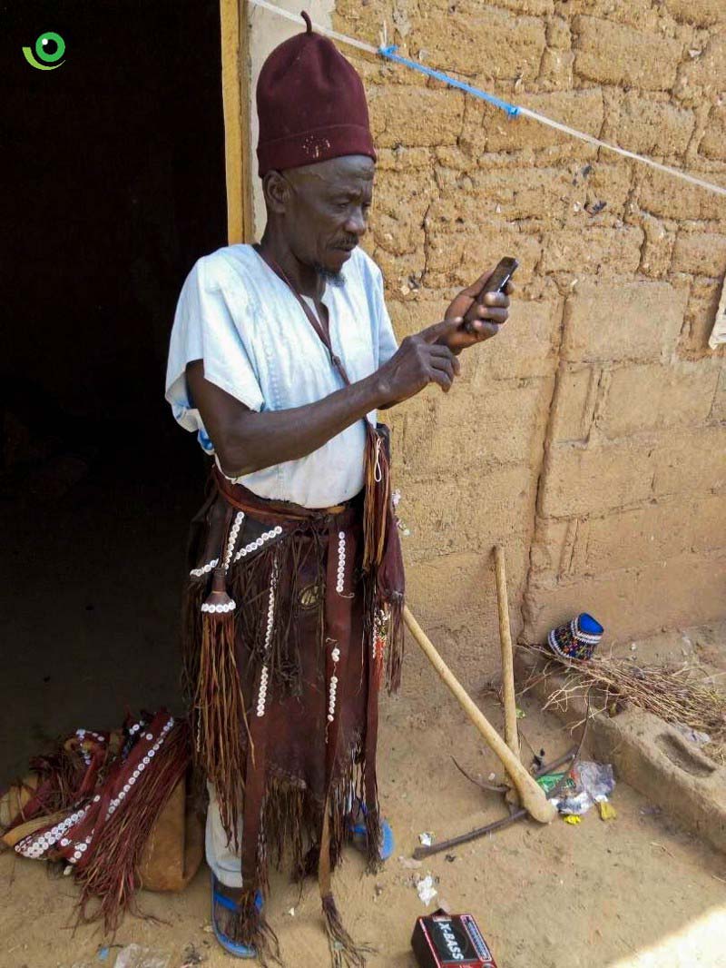 A local traditional healer, who doubles as AVADAR community volunteer in action searching for GPS coordinates as part of the App walkthrough: Photo credit: Nigeria Health Watch