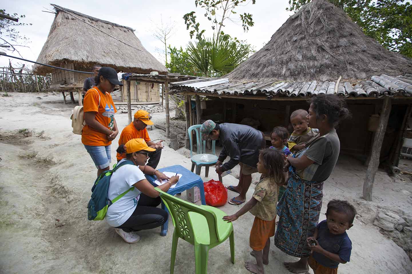 The immunisation team checks a family’s vaccination records during an outreach session in Uaimori Tula village, Viqueque Municipality. © UNICEF Timor-Leste/Soares.