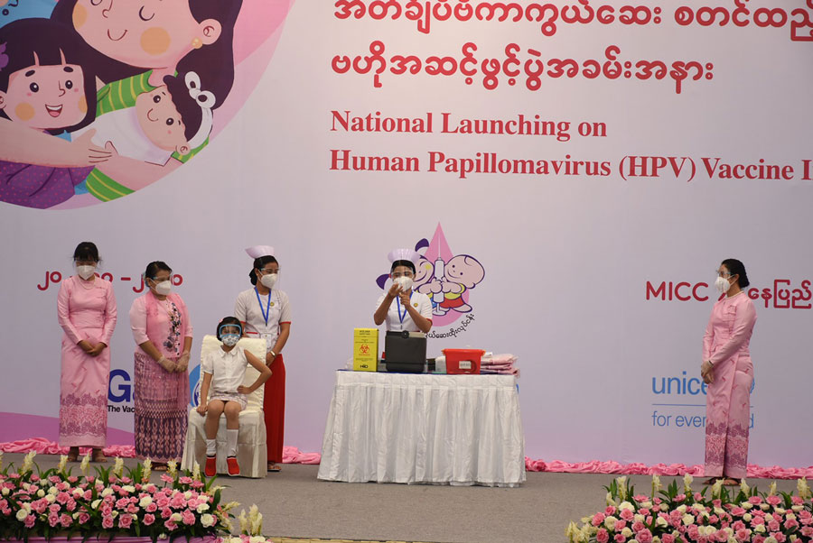The first girl to receive the HPV vaccine waits on stage as the vaccine is prepared. Gavi/2020