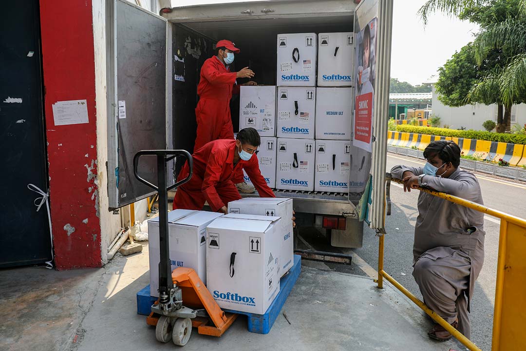 Health workers offloading the Pfizer COVID-19 vaccine at the National Institute of Health (NIH) Islamabad, Pakistan.