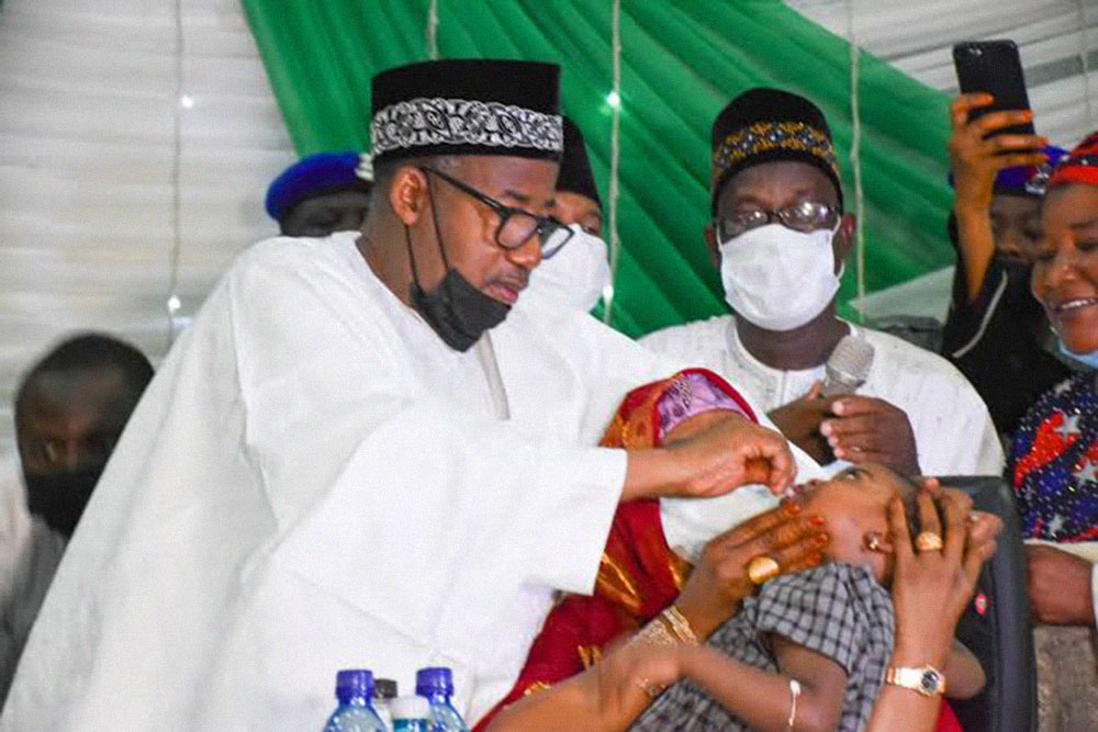 Bauchi State governor, Bala Mohammed, gives the oral cholera vaccine to a child Credits: Bauchi State Government, Ripplesnigeria, Dailyvendor