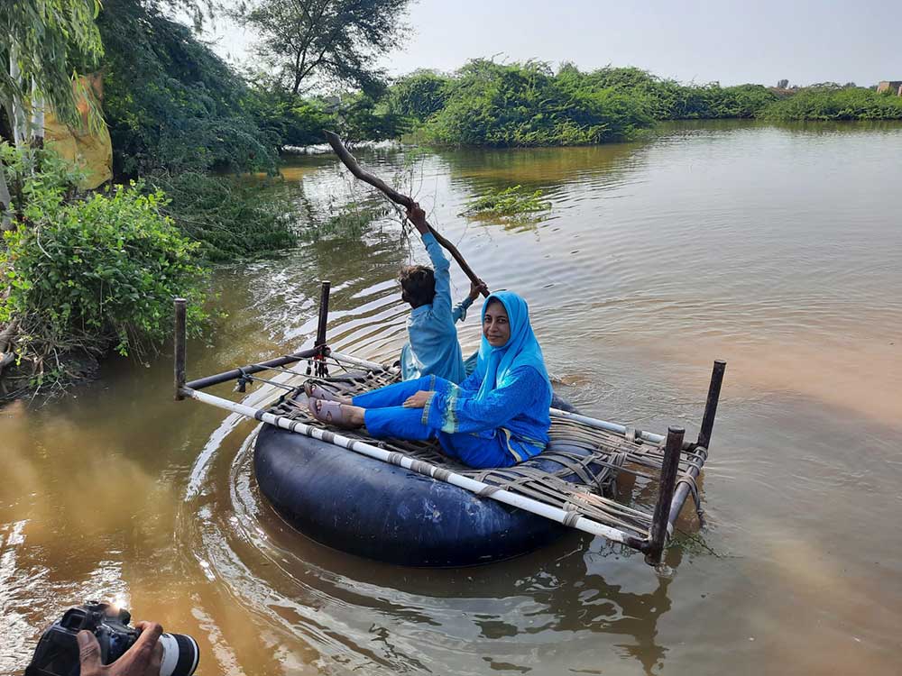 Dr Sadiqa Fayyaz moves to a remote area of Dado District via a man-made boat. Credit: Saadeqa Khan