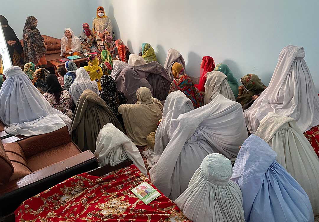A group of women gather in the drawing room of a community elder in Masha Mansoor to discuss vaccination. Credit: Huma Khawar