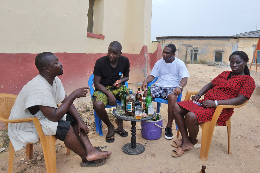 Nana Addae Mensah speaks to friends near his home at Anafo. Credit: Kwame Appiah