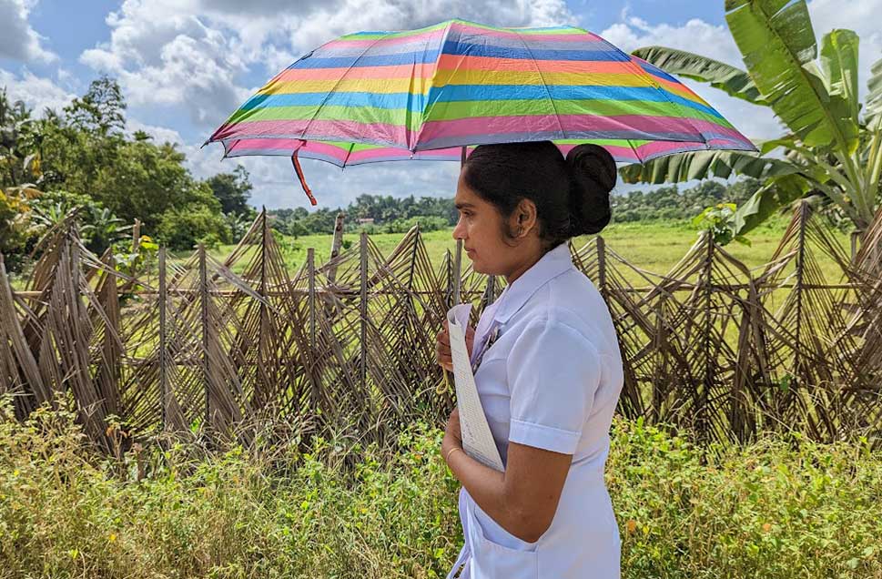 PHM Susangi-miss walking to meet a new mother in Gorakapitiya. Credit: Aanya Wipulasena: