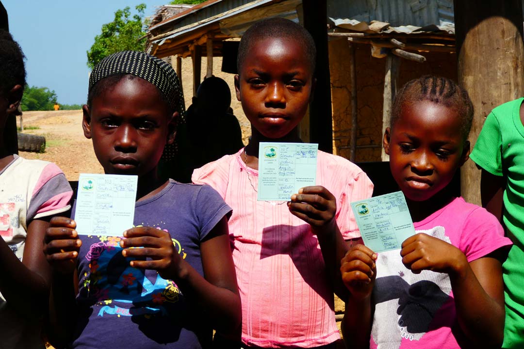 Three girls holding their HPV vaccination cards during a vaccination session in Liberia. Credit: Gavi/2016/Duncan Graham-Rowe