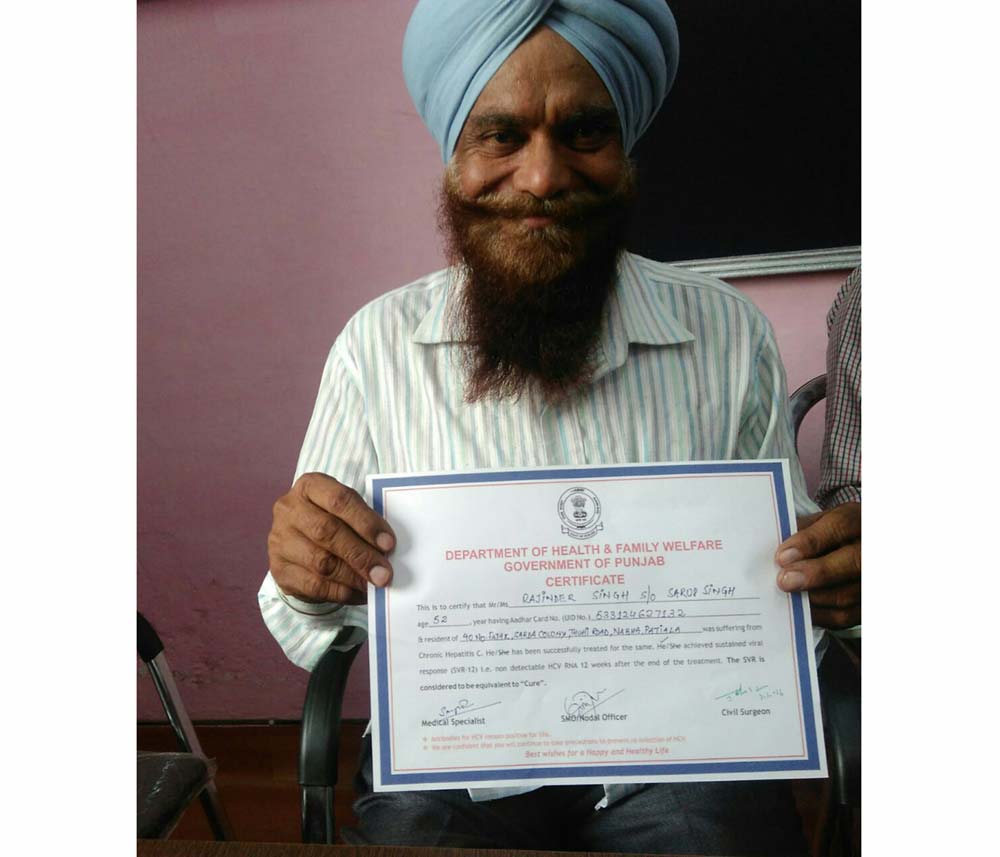 A beneficiary from a village in Patiala displays a recovery certificate issued in his favour after successfully undergoing government sponsored free treatment for Hepatitis-C. Credit: Gurmeet Singh