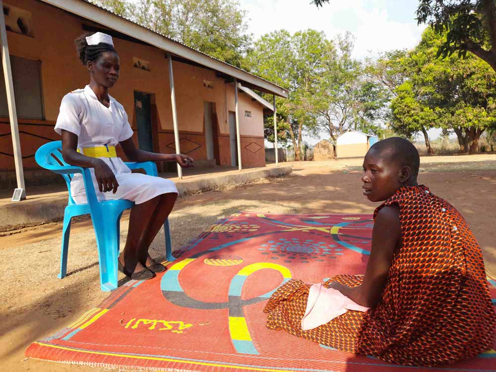 Aber Salume, a registered nurse at the Archbishop John Baptist Odama Care Center, works with a child who has nodding syndrome. Most of the children enrolled at the center are those with a severe form of the disease, she said: “Children who have developed psychosis, those who are psychiatric patients,” and those who “are victims of developmental retardation.” Credit: Pat Robert Larubi