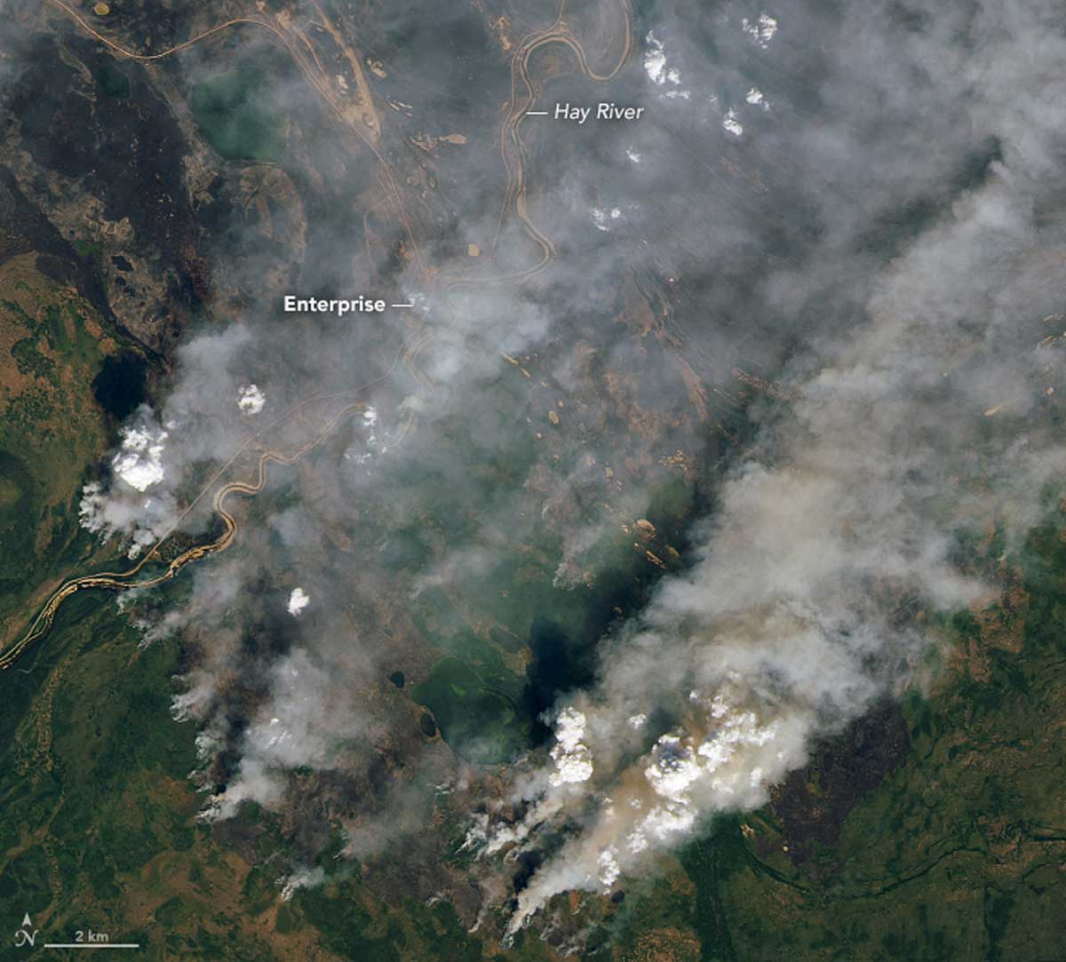 Smoke from wildfires in the Northwest Territories, in northern Canada, on August 16, 2023 captured on an image from Landsat 8. Nearly a quarter of a million people were evacuated during Canada’s 2023 fire season, including two-thirds of the population of the Northwest Territories. Image by Lauren Dauphin via Wikimedia Commons (Public domain).