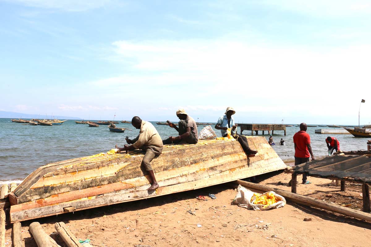 Ladislas Ndikumana with his colleagues repairing a boat in one of the fishing sites in Rumonge. Credit: Moses Havyarimana