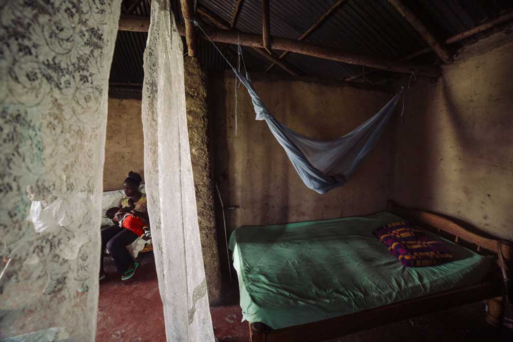 Faith Walucho, resident of Nyalenda B in Kisumu, dropping her daughter Nia off at a neighbor's home for nannying. As a single mother, she's concerned about her children's health and always ensures that they sleep in net-enclosed beds.