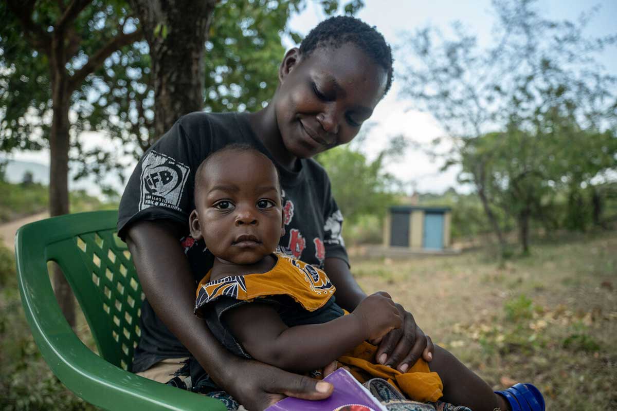Benta Achieng, 24, with her 9 month-old son Raymond Biha in Sindo, Kenya. As she says: “Today my child has received the third dose of malaria [vaccine] and I feel he’s protected, better than his older siblings who did not have a chance to receive.” Gavi/2023/Kelvin Juma