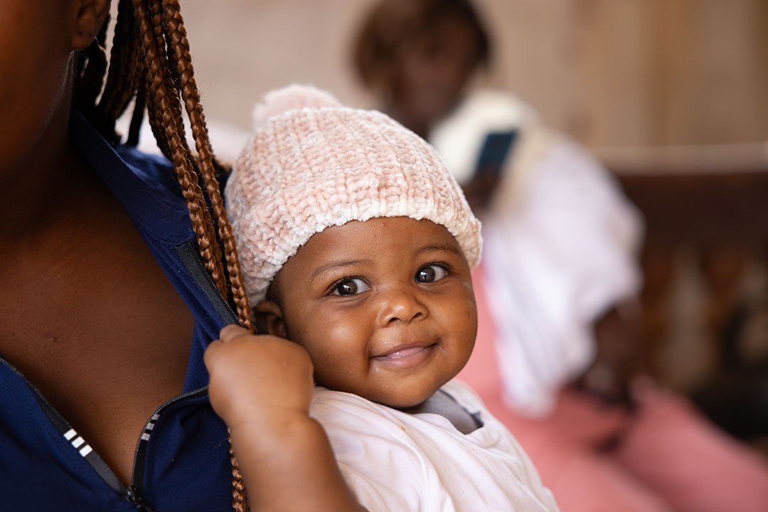 [16:00] Maya Prabhu (Consultant) Six-month-old Fiona waits to get vaccinated against malaria at the Soa District Hospital in Cameroon.