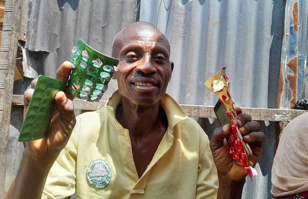 Solomon Adedoyin Gbajobi, 58-year-old TB patient happily displaying drugs to confirm that he is about to complete his therapy