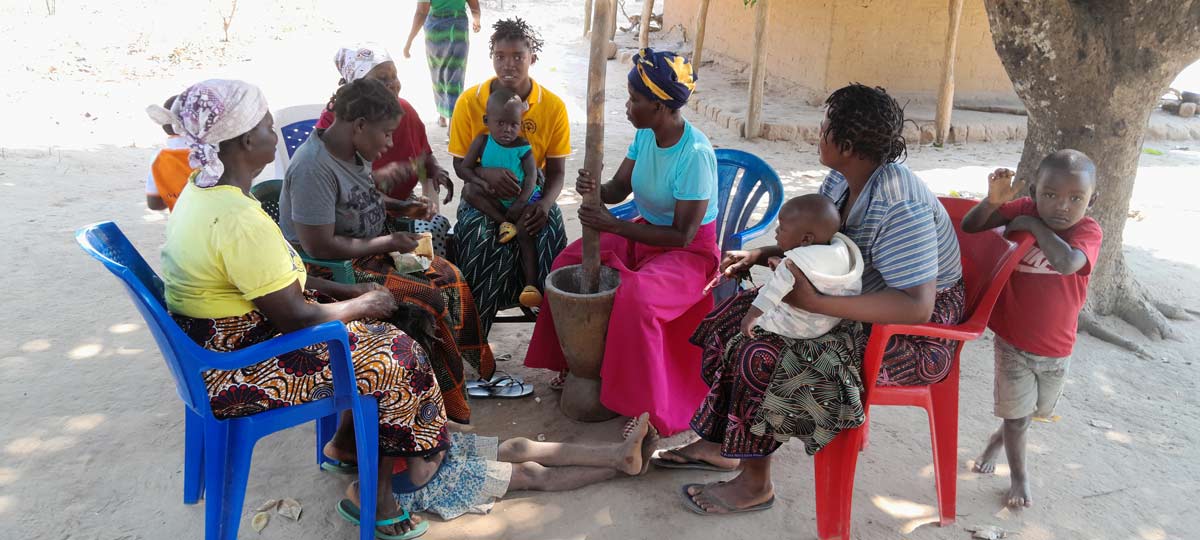 Joana Nauepa talking vaccines with fellow villagers. Credit: Charles Mangwiro.