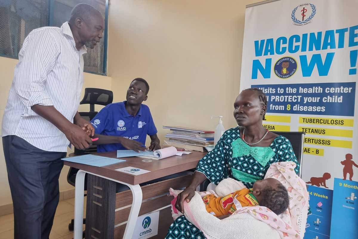 Deputy head of EPI at Al Sabbah Hospital John Elia talking to a mother. Credit: Winnie Cirino.