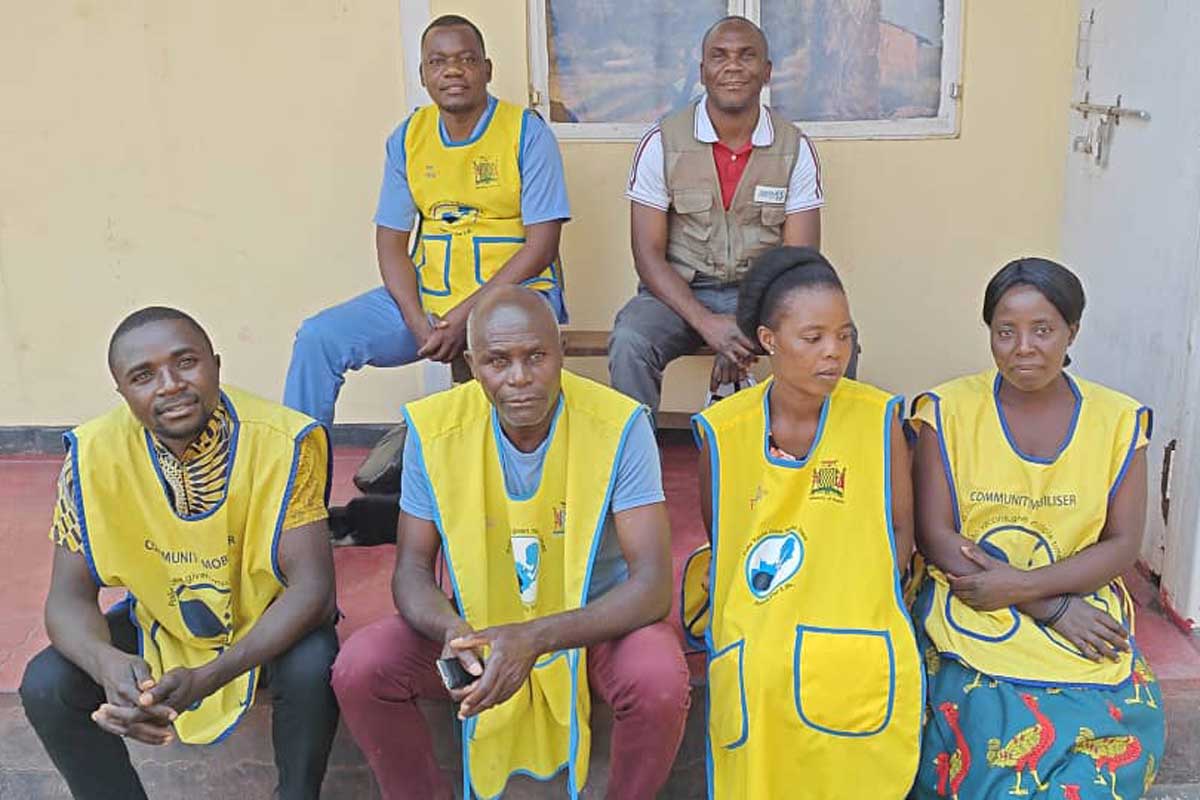 Orbrie Chewe (in grey vest) with community health mobilisers. Credit: Orbrie Chew