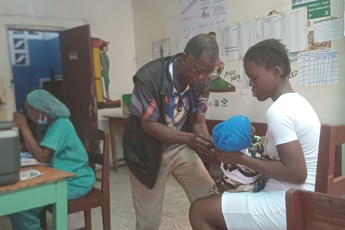 Saturday Wesseh, the head vaccinator administered the jab to Favor Weah's son.jpg