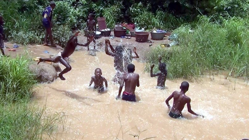 Children bathe in a stream in Taiakou, northern Benin – a common practice in rural areas, but one that exposes them to bilharzia. Credit: Ministry of Health