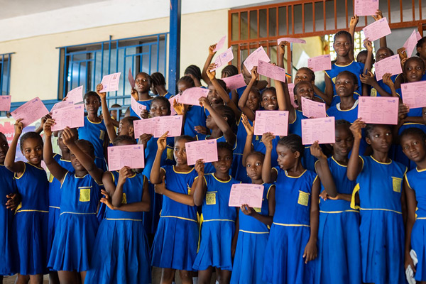 Students hold up their paperwork after receiving the Human Papillomavirus Vaccine (HPV) during a vaccination campaign in Sierra Leone in May 2023. Credit: Gavi, Dominique Fofanah