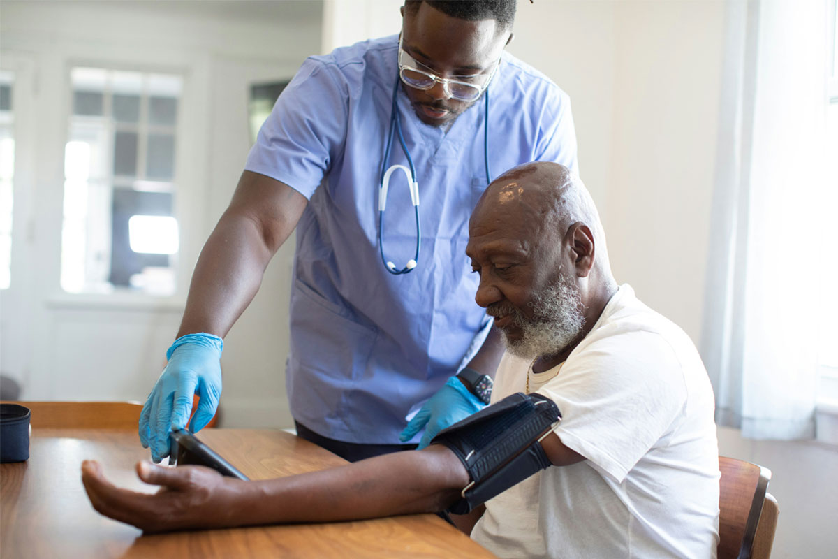 Health worker measuring a patient's blood preassure. Credit: nappystudio via Unsplash