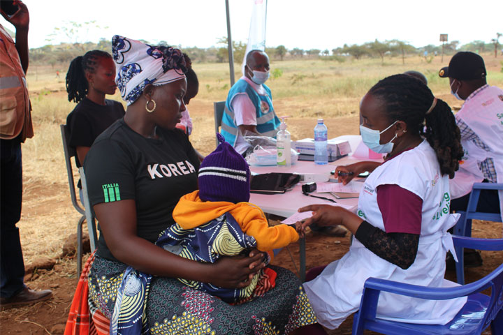 A mother awaits as her child receives treatment at Inkosuk village in Kajiado County during Entepesi Kenya's medical camp. Credit: Susan Methamo