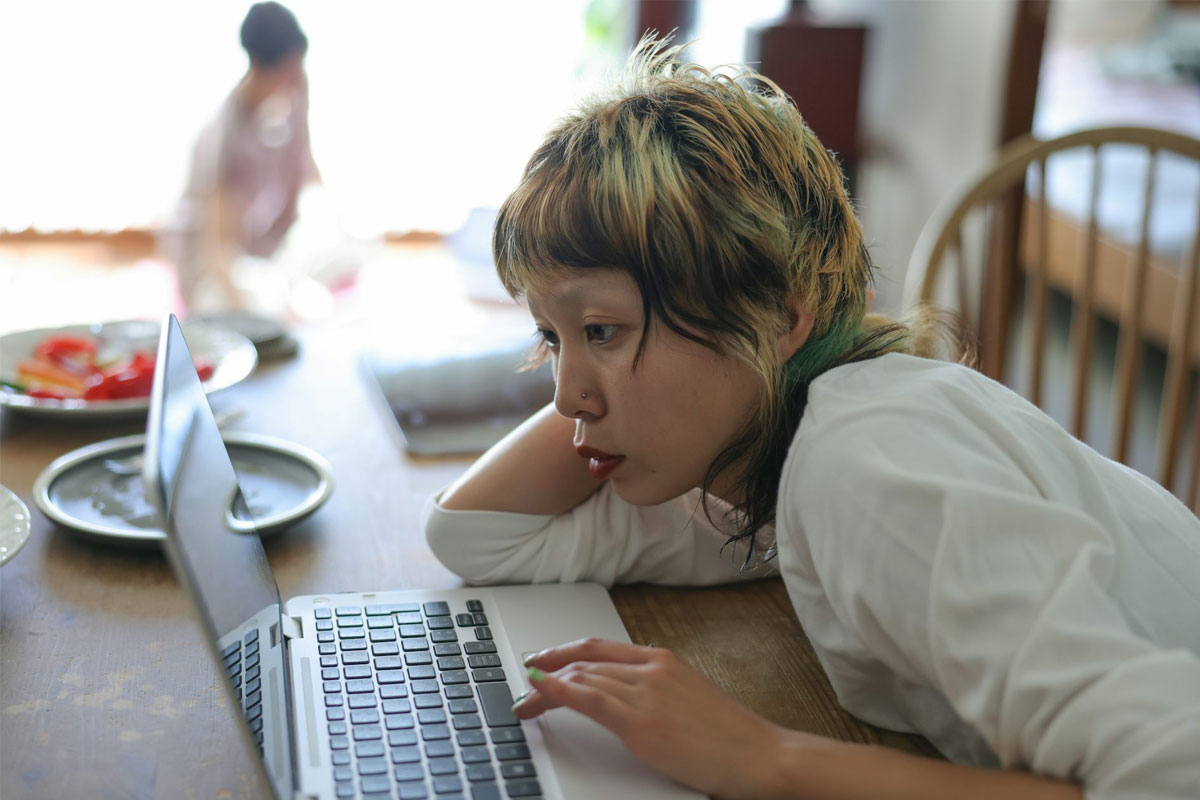 Young person working on a laptop. Credit: Kyonntra/ Getty Images